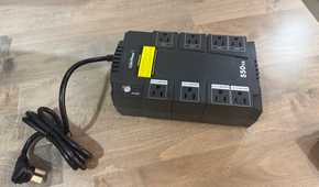 CyberPower 550VA UPS with coiled power cord on desk