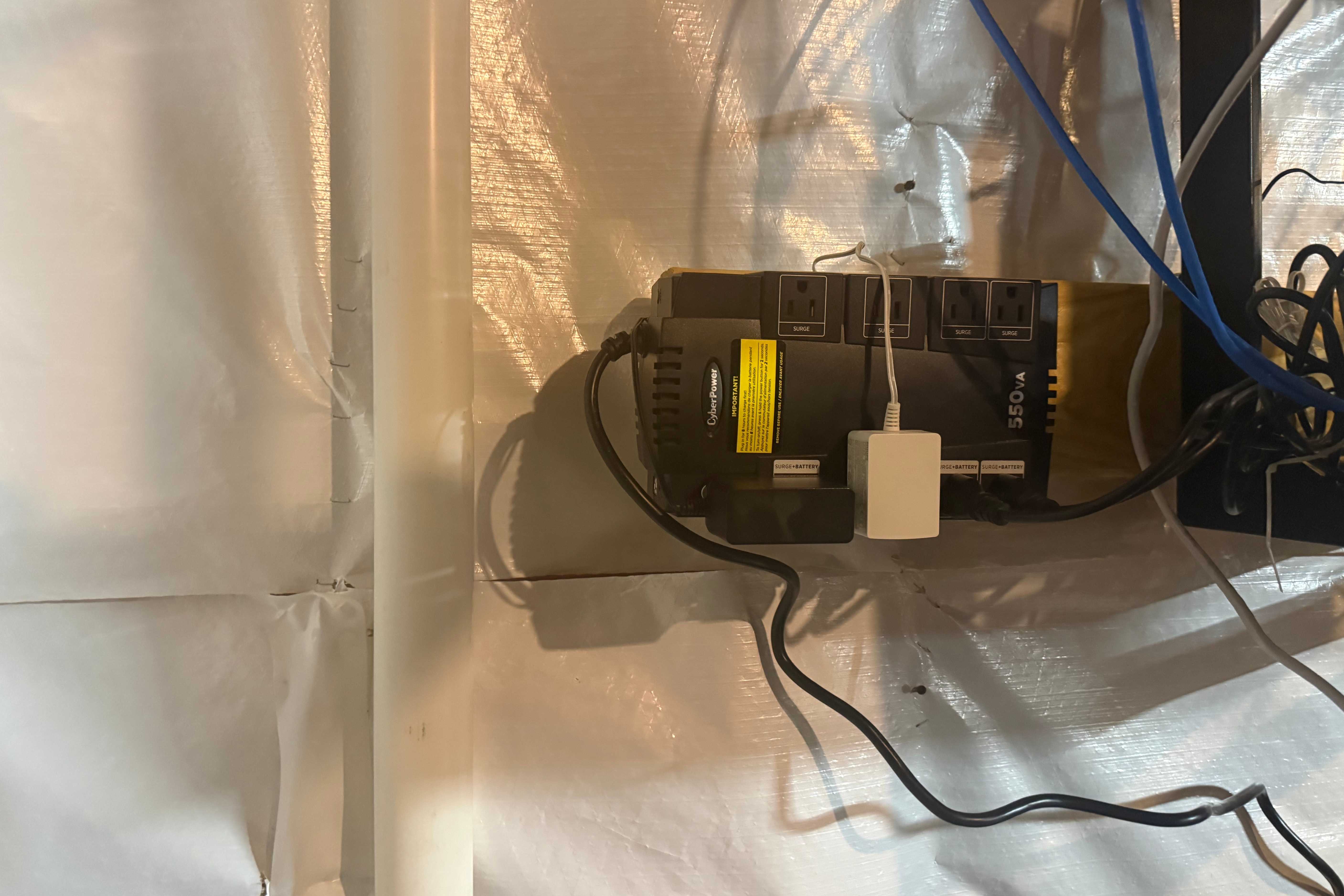 CyberPower UPS in utility area with device charging