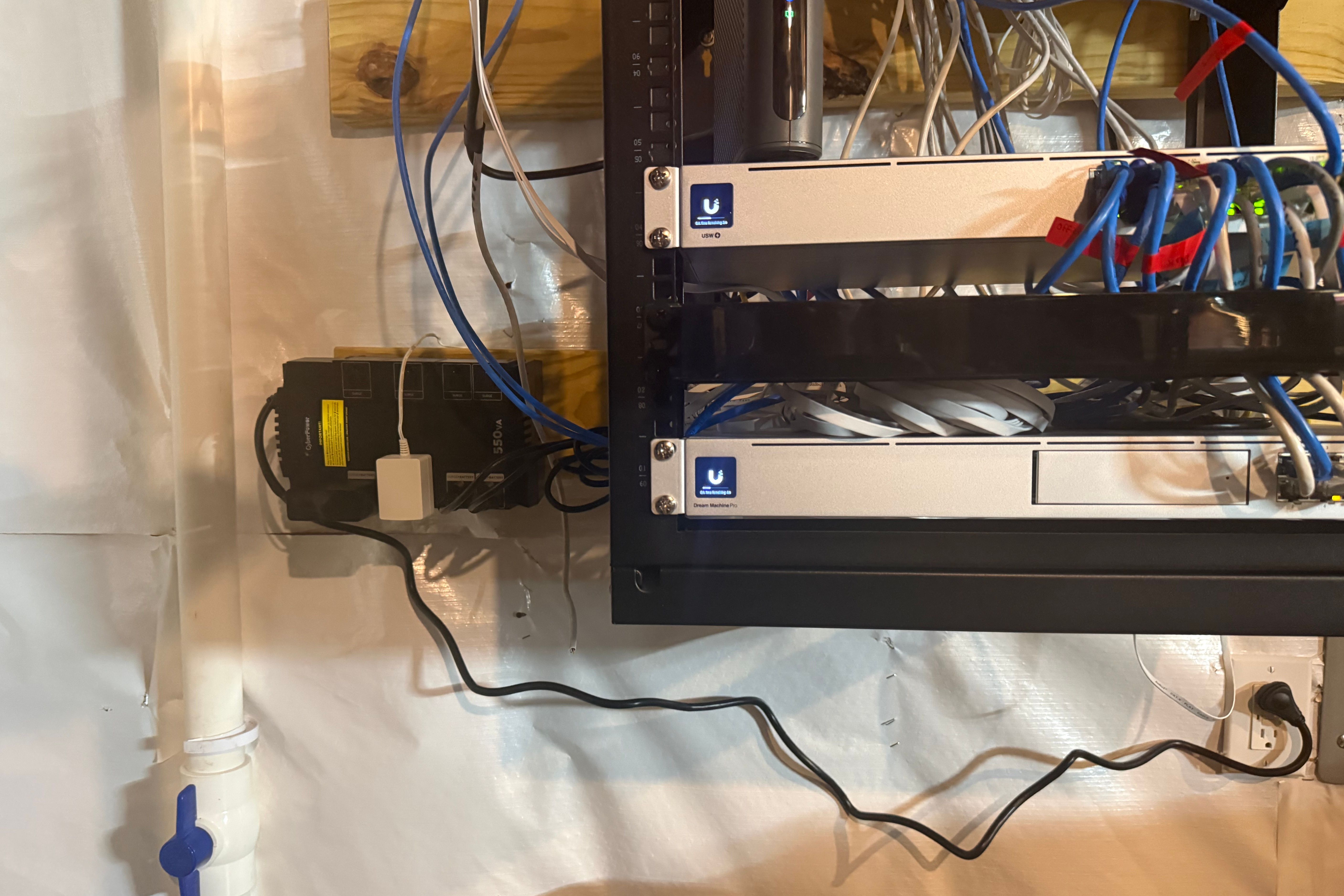 CyberPower UPS installed beside home network rack