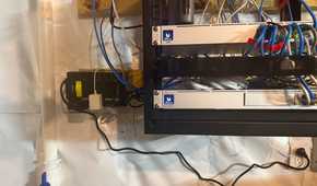 CyberPower UPS installed beside home network rack