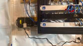 CyberPower UPS installed beside home network rack