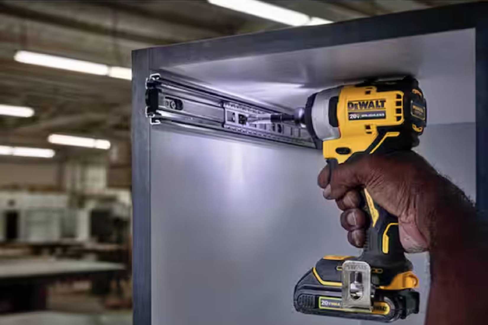 Atomic 20V Max Lithium-Ion Brushless Cordless Compact 1/4 in. Impact Driver Kit with 2.0Ah Battery and Charger screwing in a bracket.
