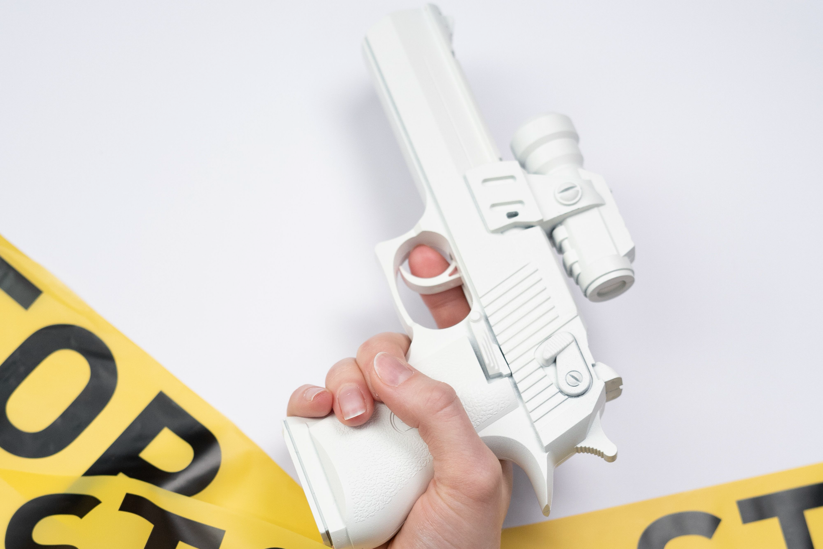 Picture of plastic white gun held in hand