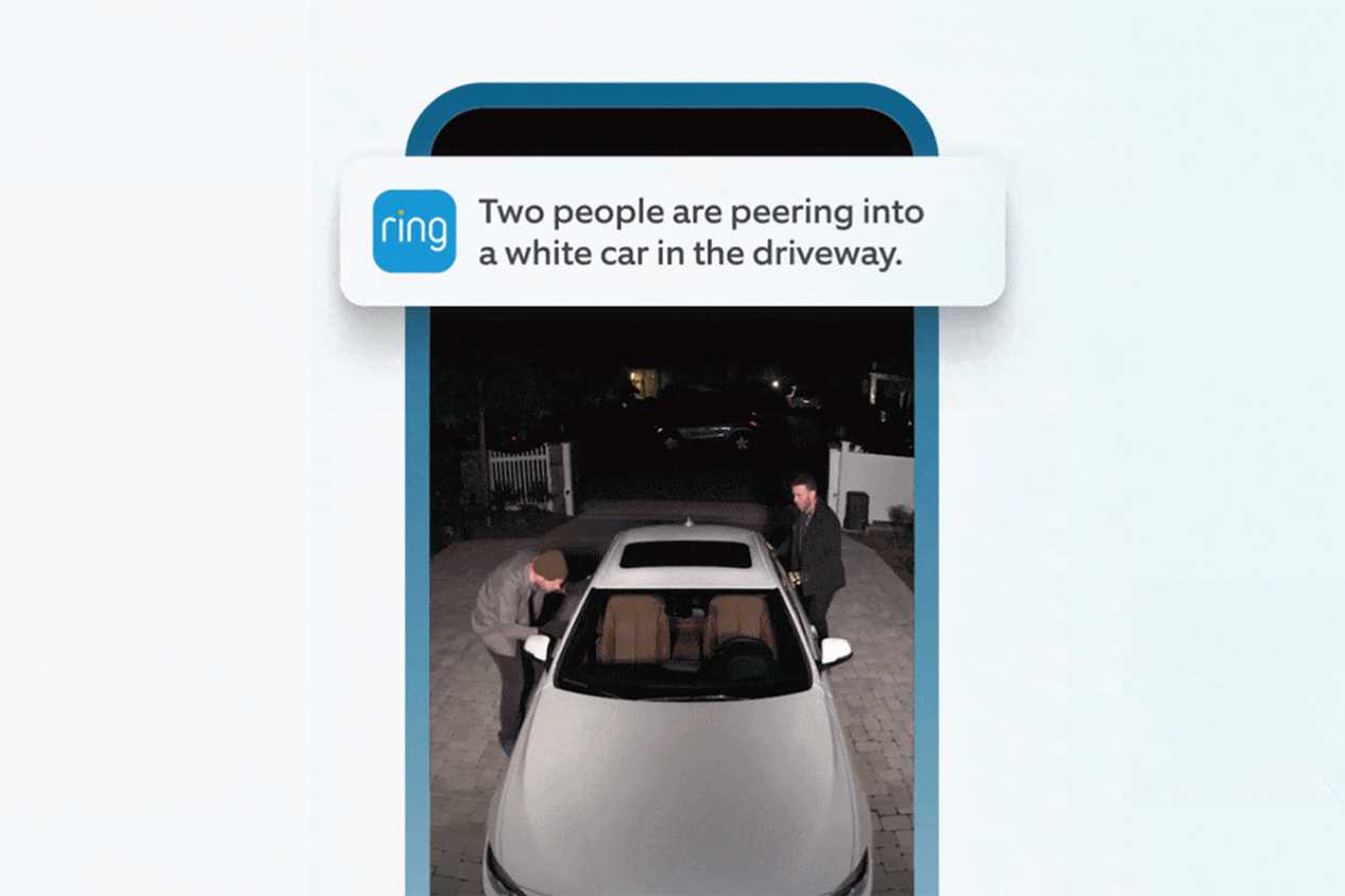 A phone showing the Ring camera app with two men peering into a car.