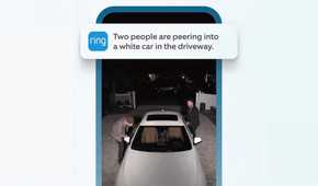 A phone showing the Ring camera app with two men peering into a car.