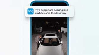 A phone showing the Ring camera app with two men peering into a car.