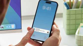 A finger touching a phone showing a Ring notification about a dog chewing furniture.