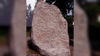 Ancient runestone standing outside a building