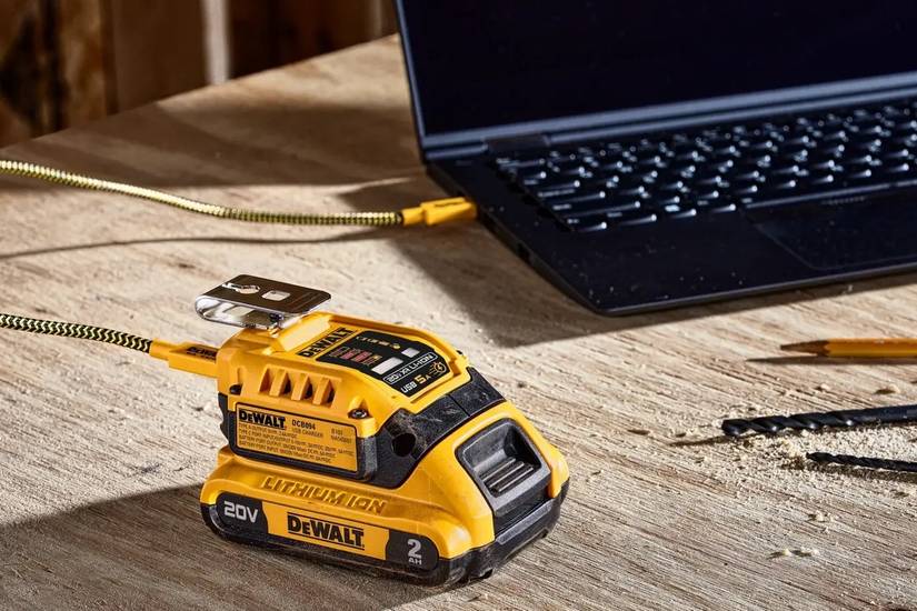 dewalt dcb094k on table with laptop