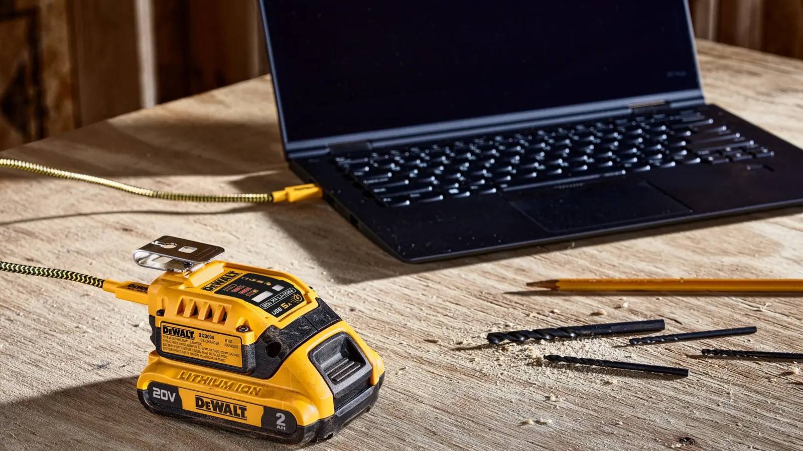 dewalt dcb094k usb kit on wood table charging laptop