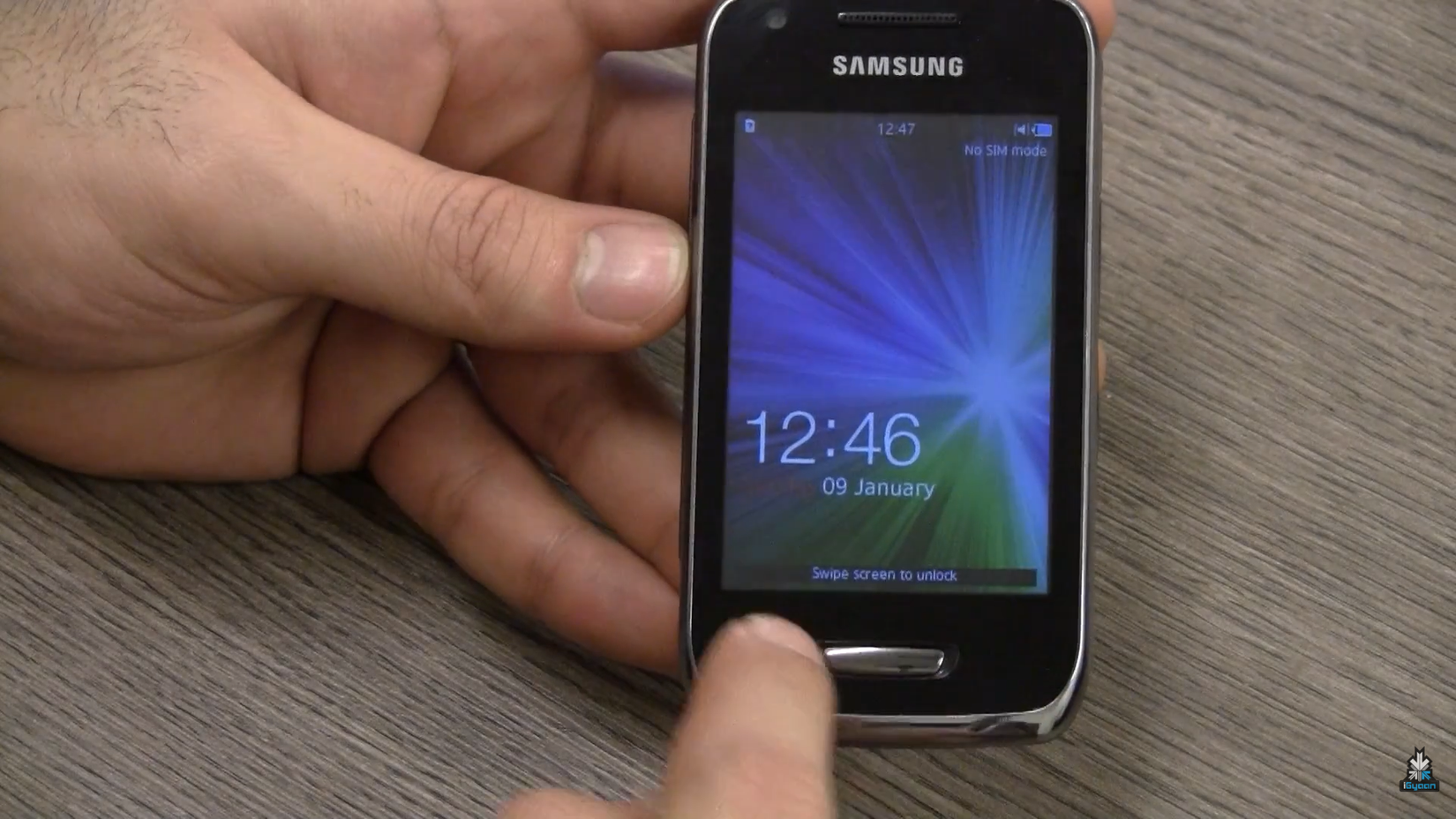 Person holding a Samsung Wave Y smartphone.