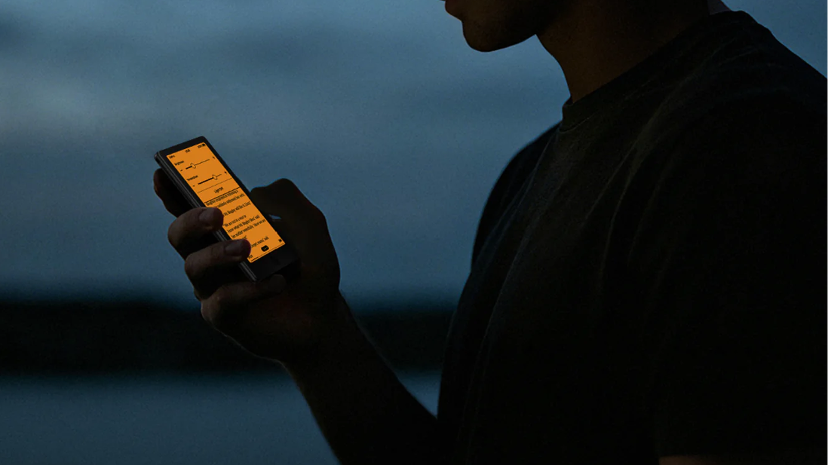 Xteink X4 Pro pocket eReader with adjustable front light used in low-light conditions