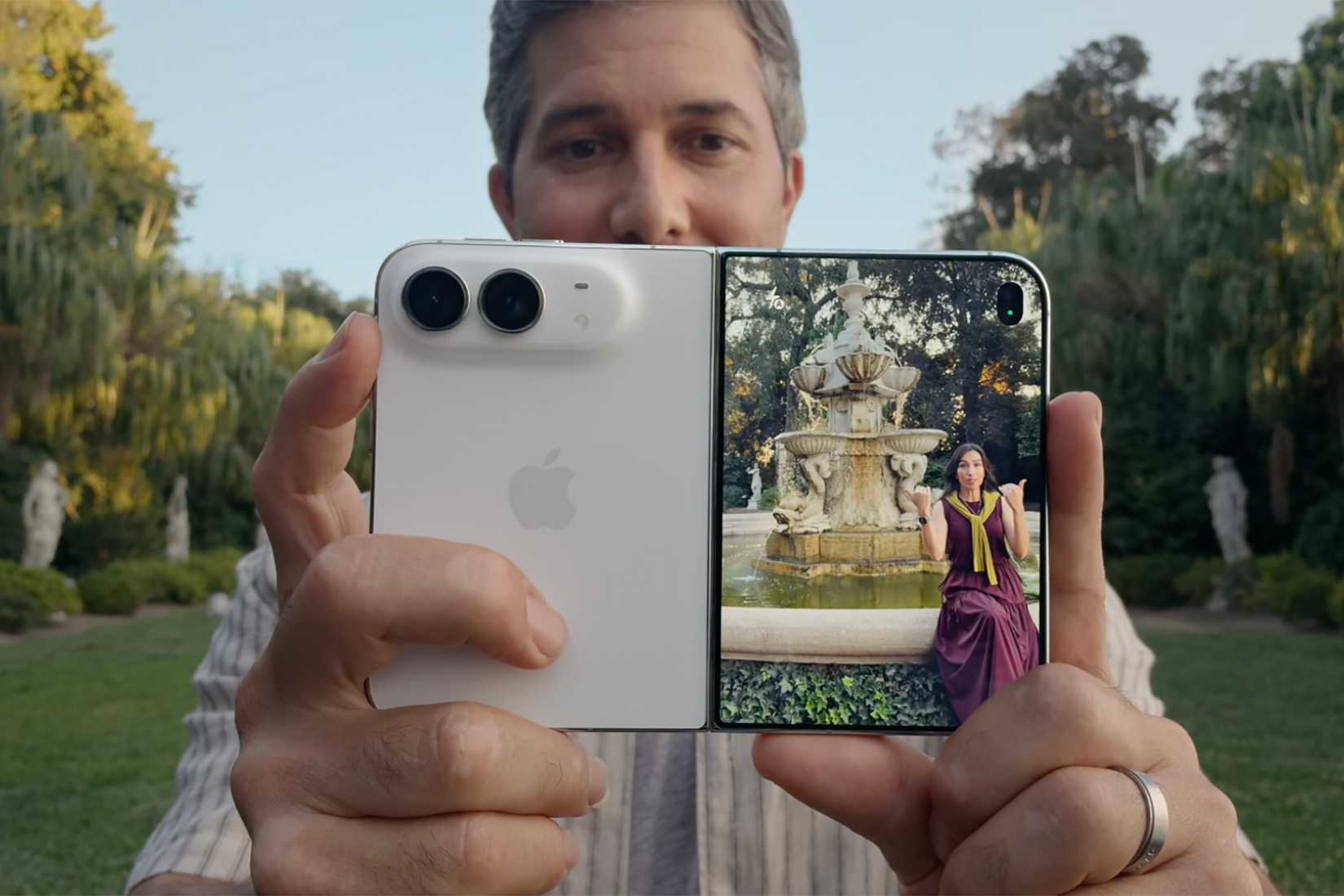 A man holding the iPhone Duo up to a woman and you can see her image in the front screen preview.