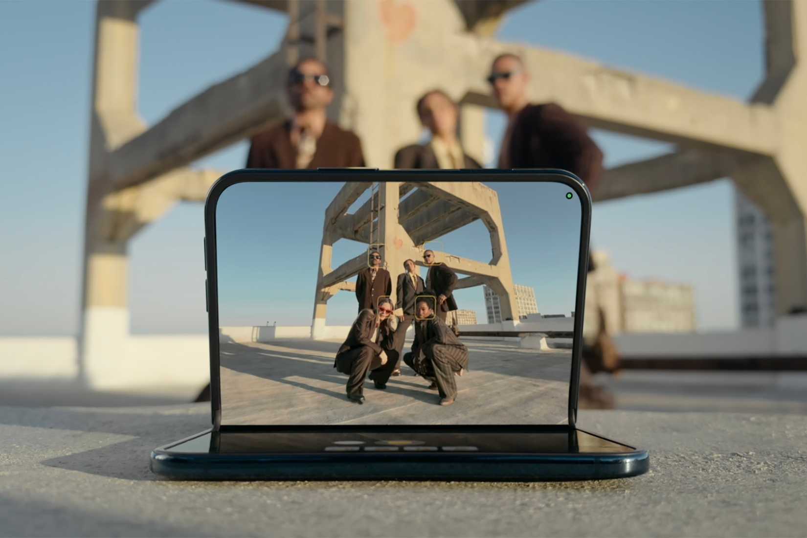 An iPhone Duo on a surface capturing a group photo.