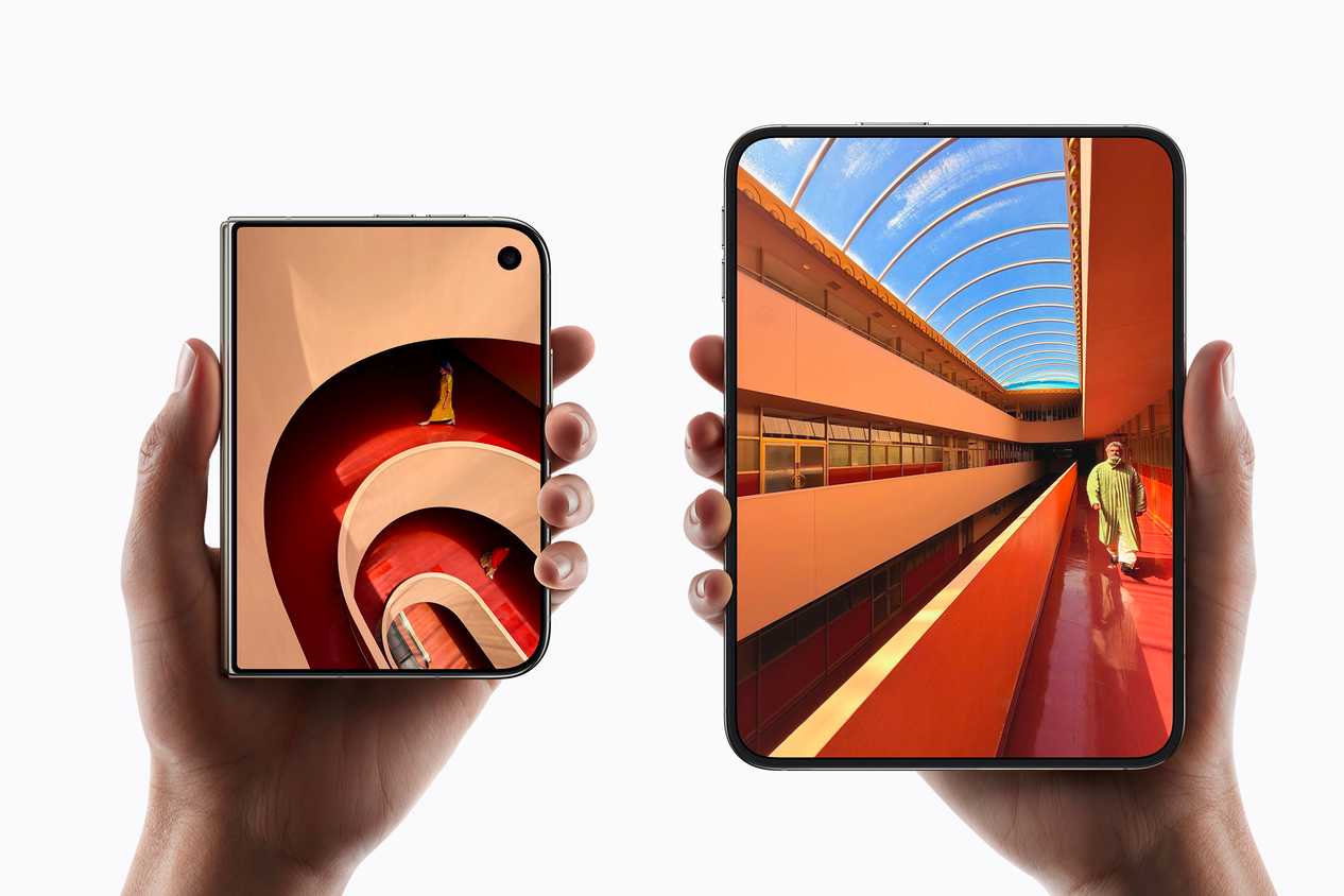 Two hands holding the iPhone Duo both open and closed.