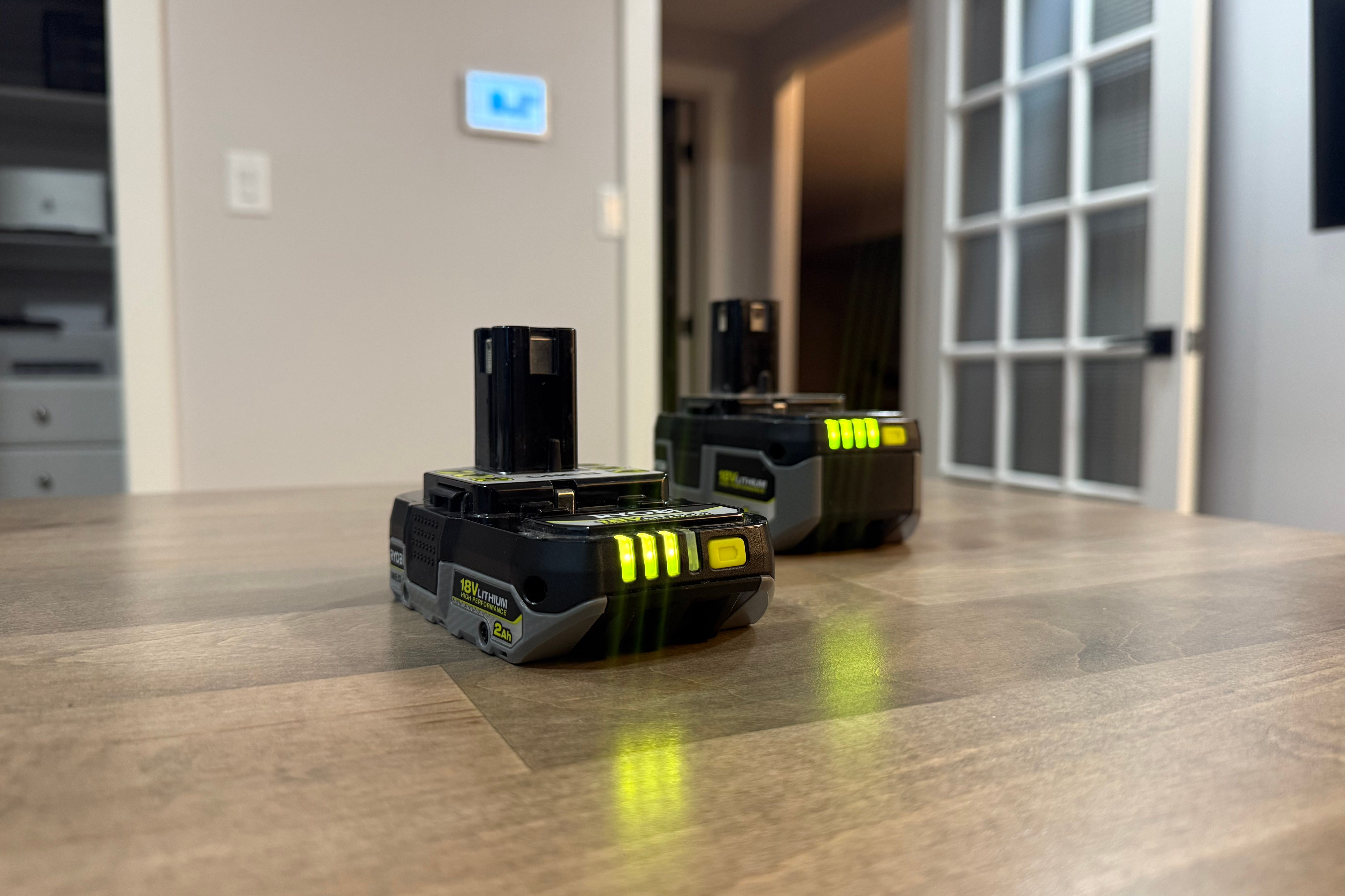 two ryobi batteries on desk