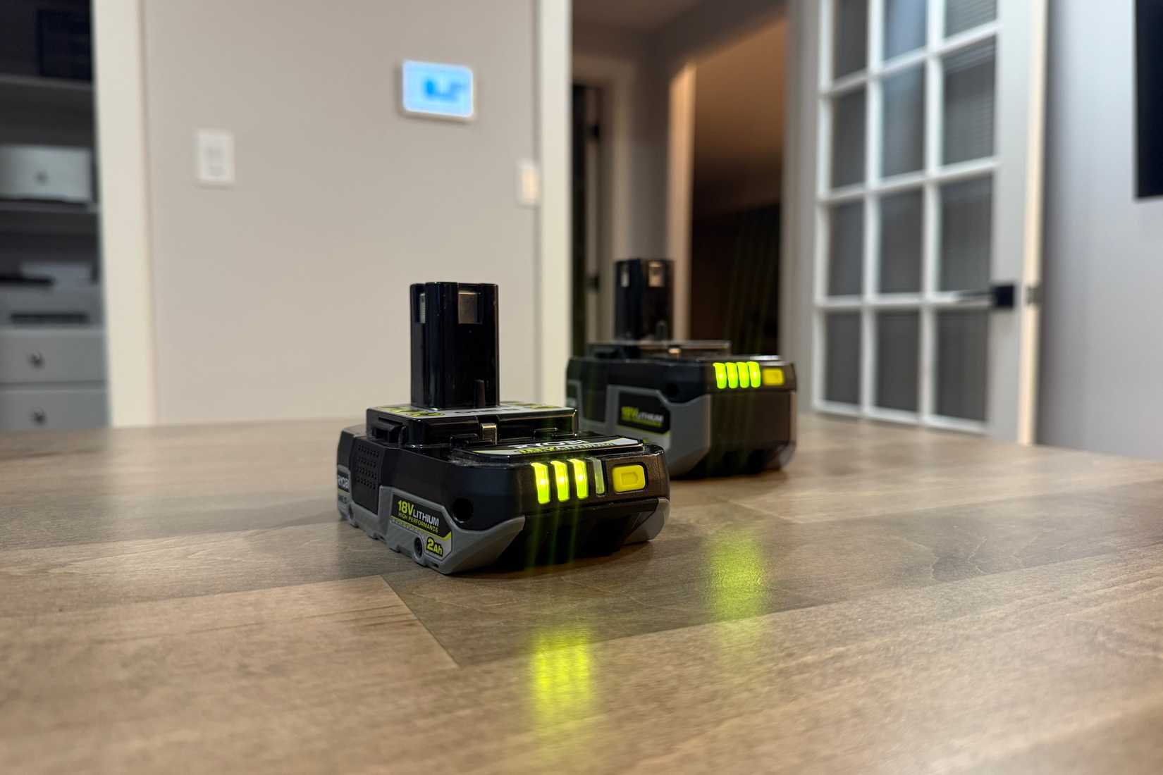 two ryobi batteries on desk
