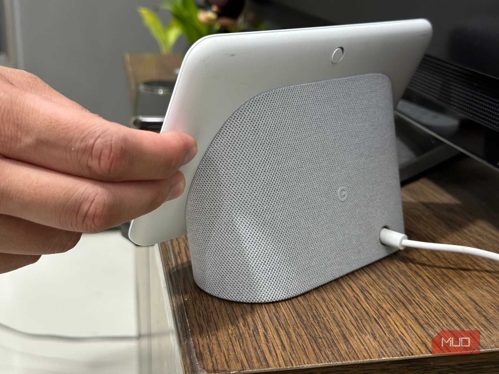 Pressing the volume up and down buttons of the Google Nest Hub simultaneously for factory reset