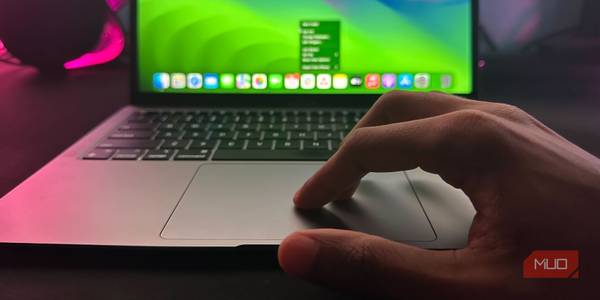 A MacBook user right-clicking on the trackpad