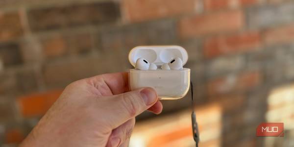 a person holding AirPods Pro enclosed in a case