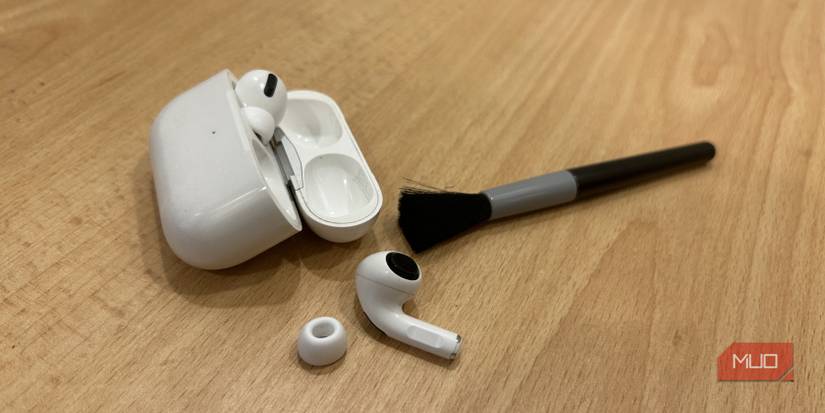 AirPods Pro on table with a cleaning brush.
