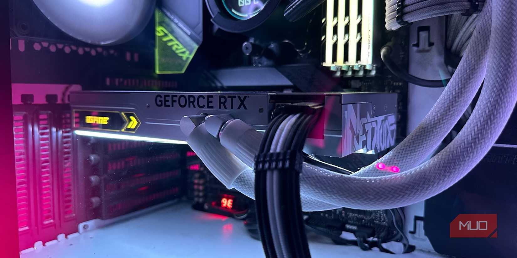 A white liquid-cooled GeForce RTX 4090 graphics card inside a PC Case