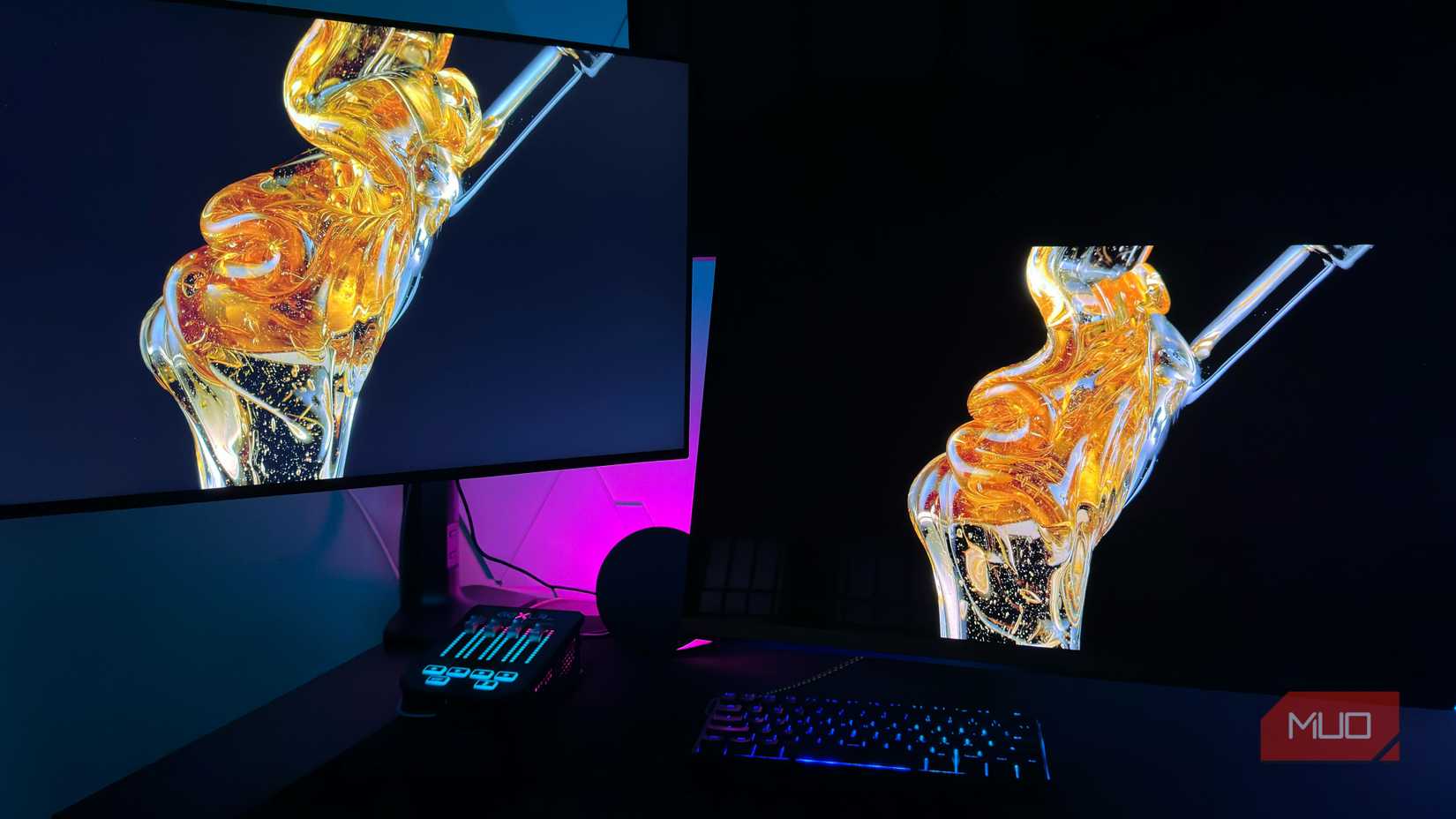OLED and LCD monitor side by side on a desk showing picture quality