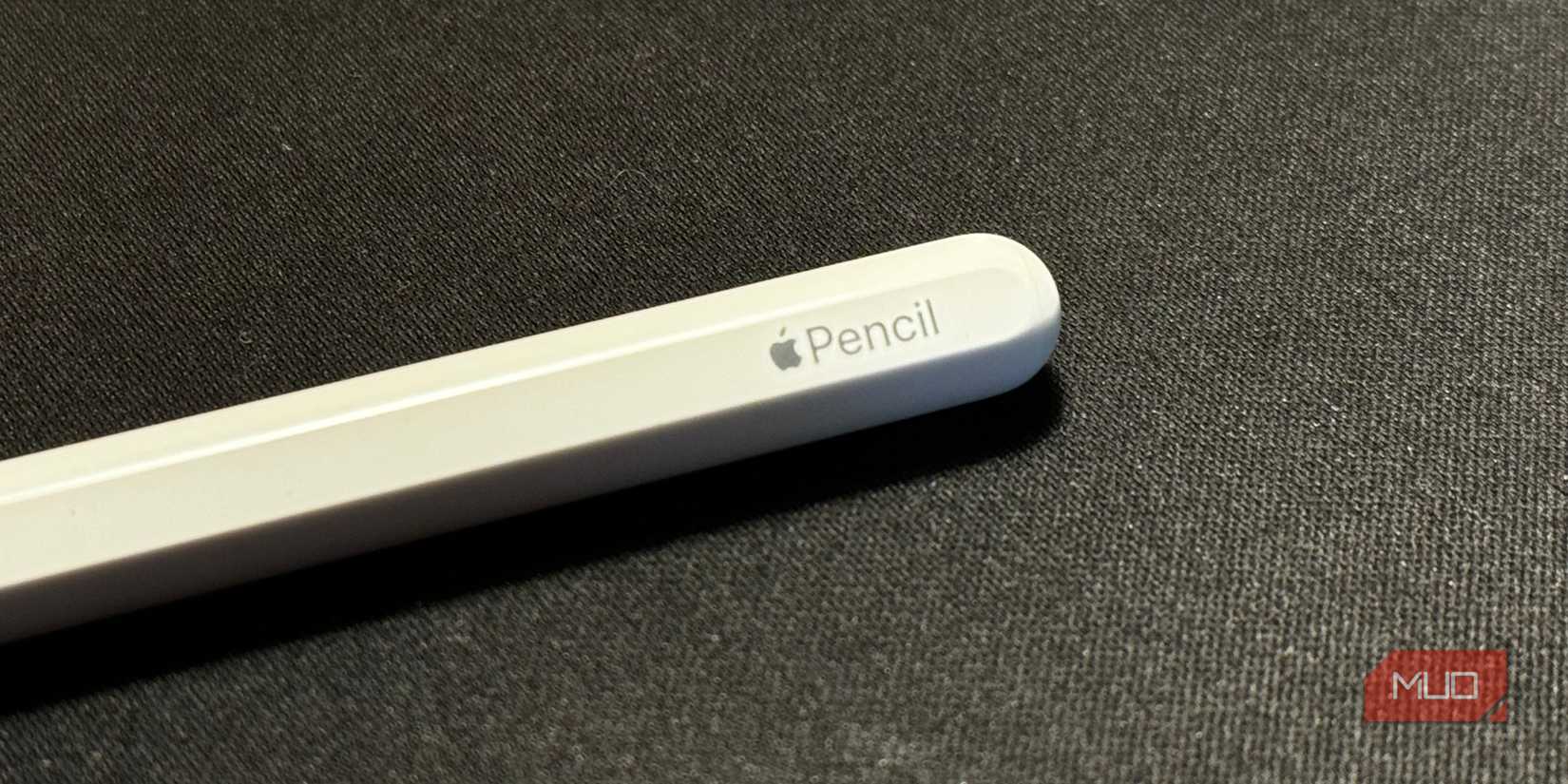 Apple Pencil Kept On A Black Surface Showing Apple Pencil Branding