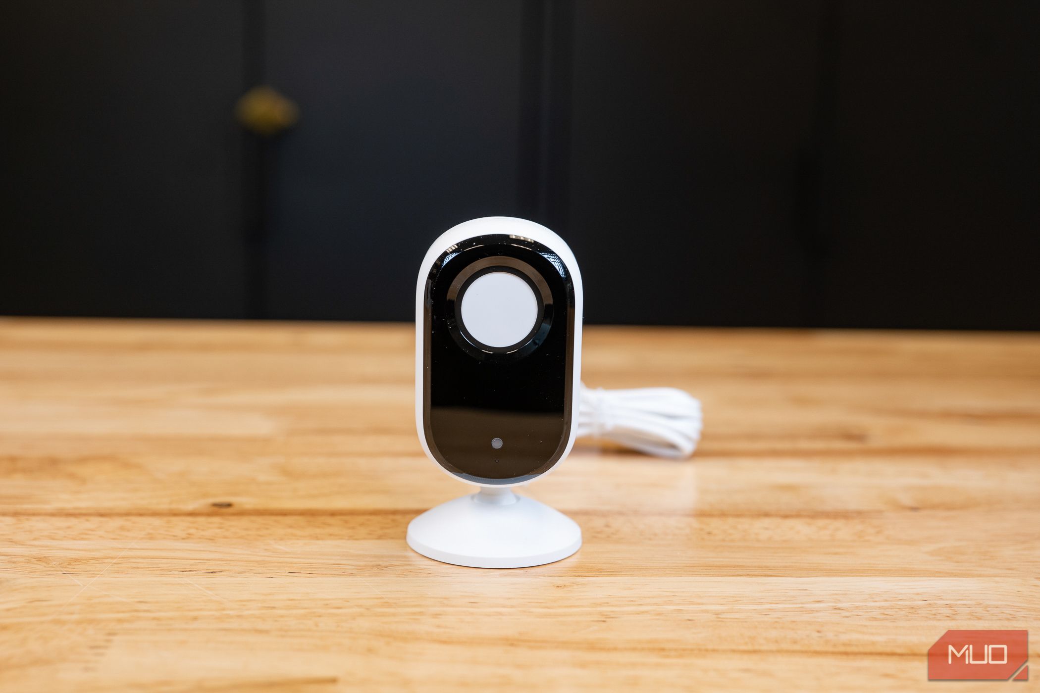 Valnet Reviews Department Arlo Essential Indoor Camera placed on table with the privacy shutter covering the lens
