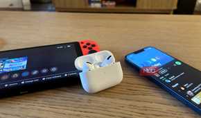 AirPods Pro with an iPhone and a Nintendo Switch in the background