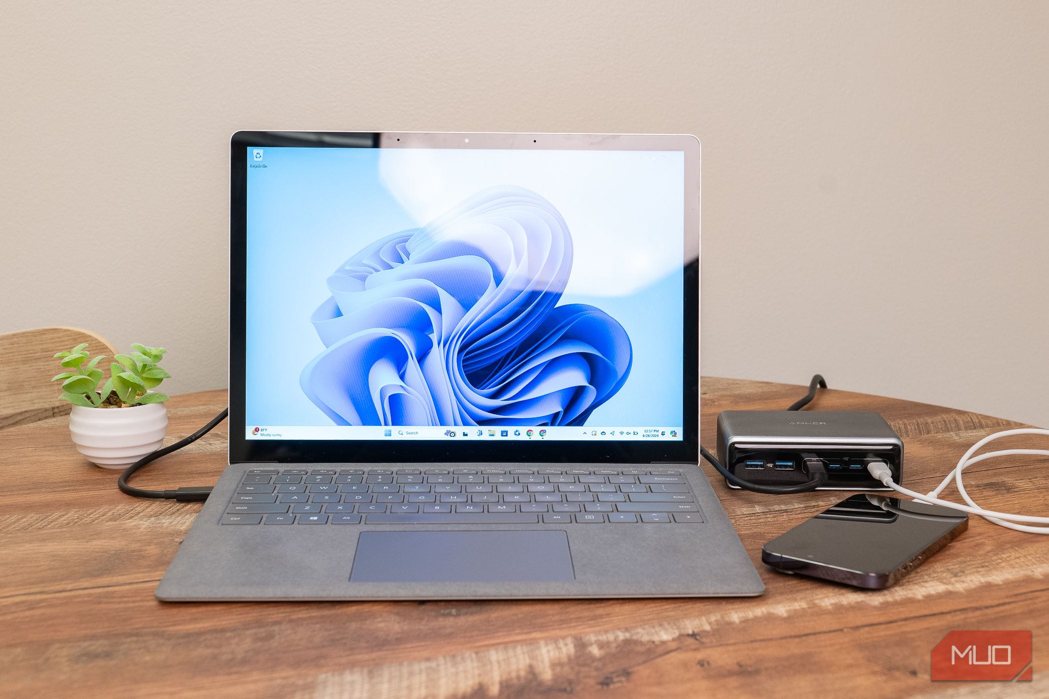 The Anker Prime 6-in-1 Charger connected to a laptop and iPhone.