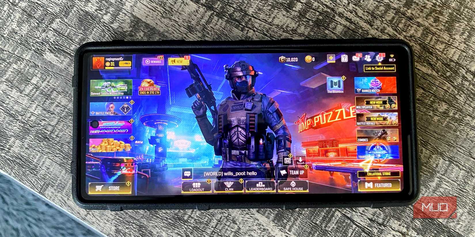 Android phone on a table top with Call of Duty Mobile game home screen displayed