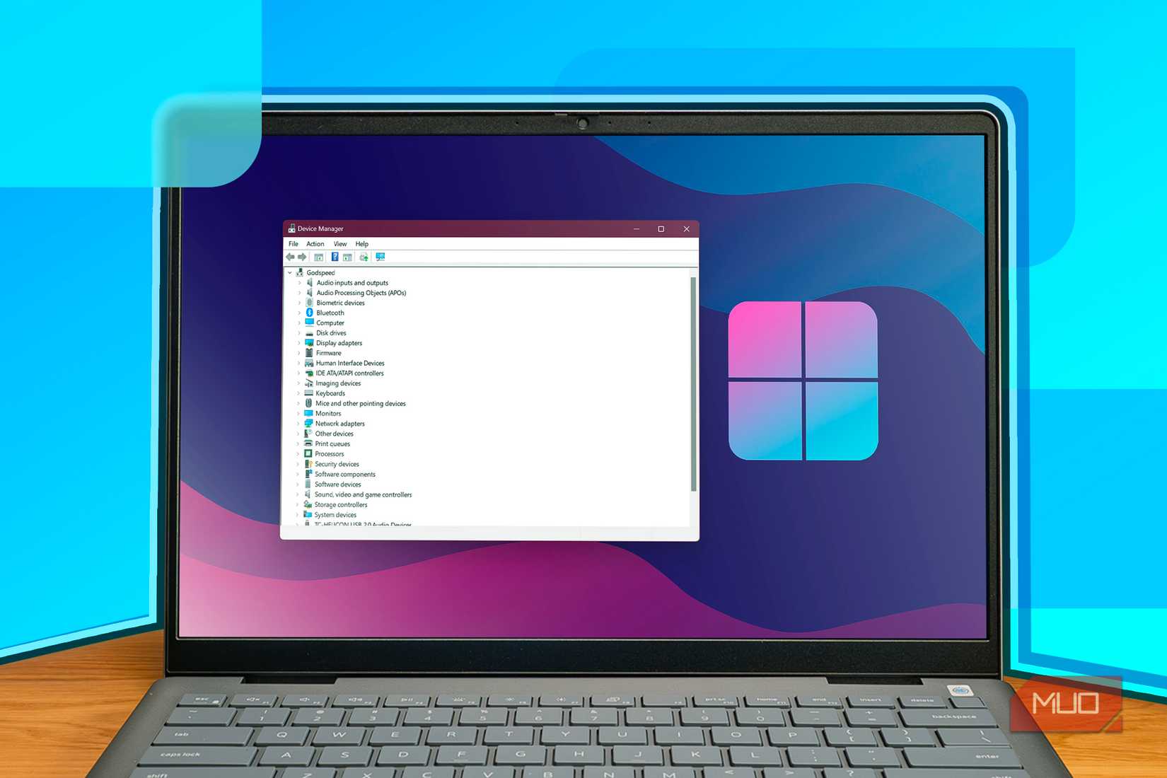 A Windows laptop with the Device Manager open.