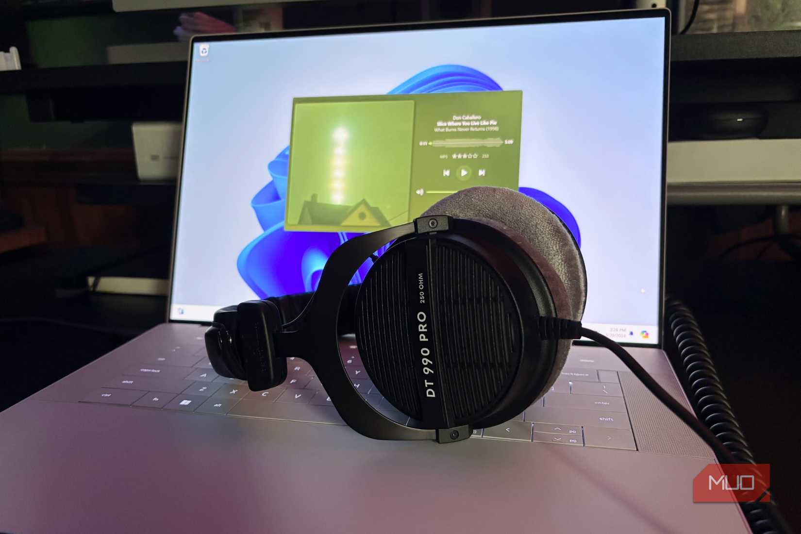 Headphones sitting on a Windows laptop playing music in Plexamp
