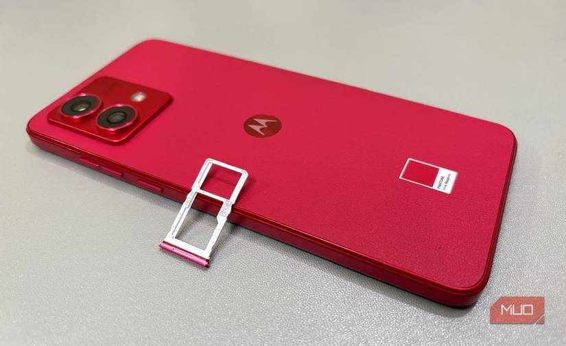 Smartphone on a gray mat with SIM tray on top