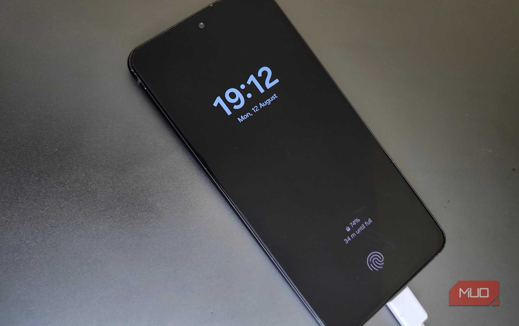 There is a Samsung phone charging on a desk