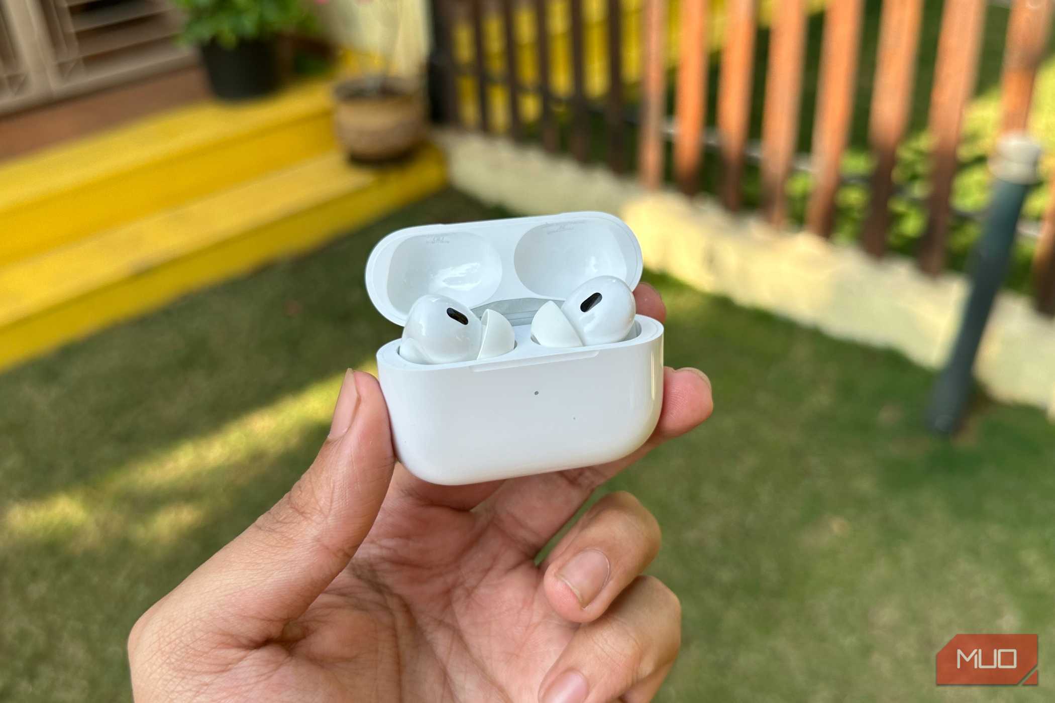 AirPods Pro 2 with case open being held in a man's hand