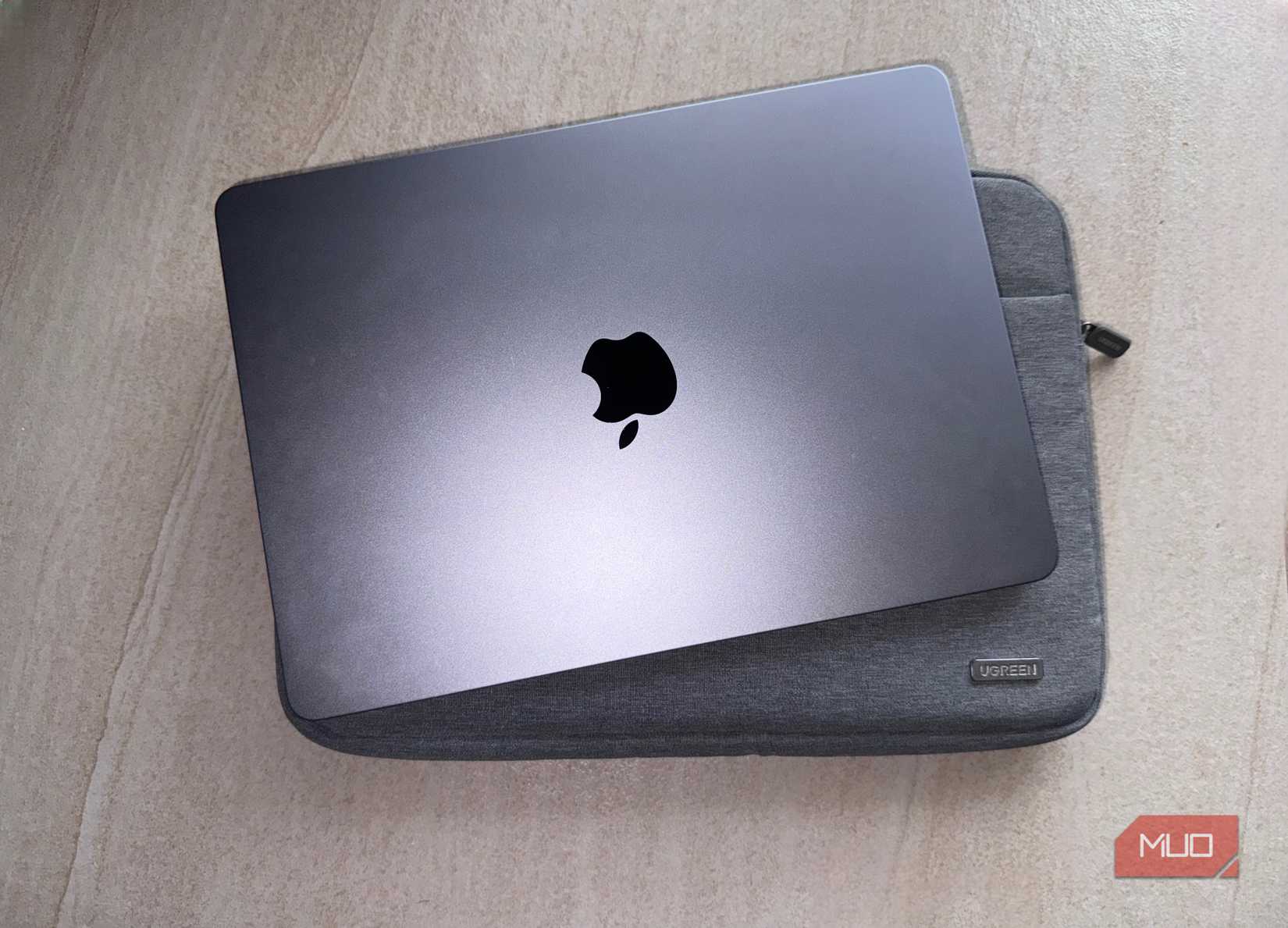 MacBook and a Ugreen sleeve on a flat surface.