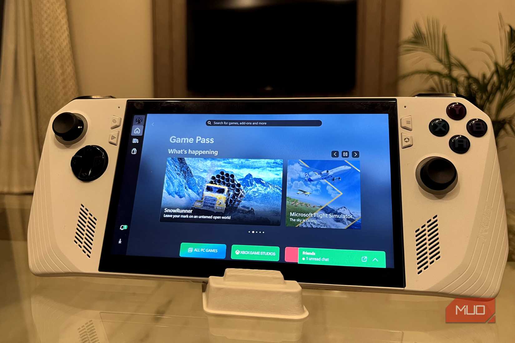 ASUS ROG Ally running the Xbox app with a TV in the background