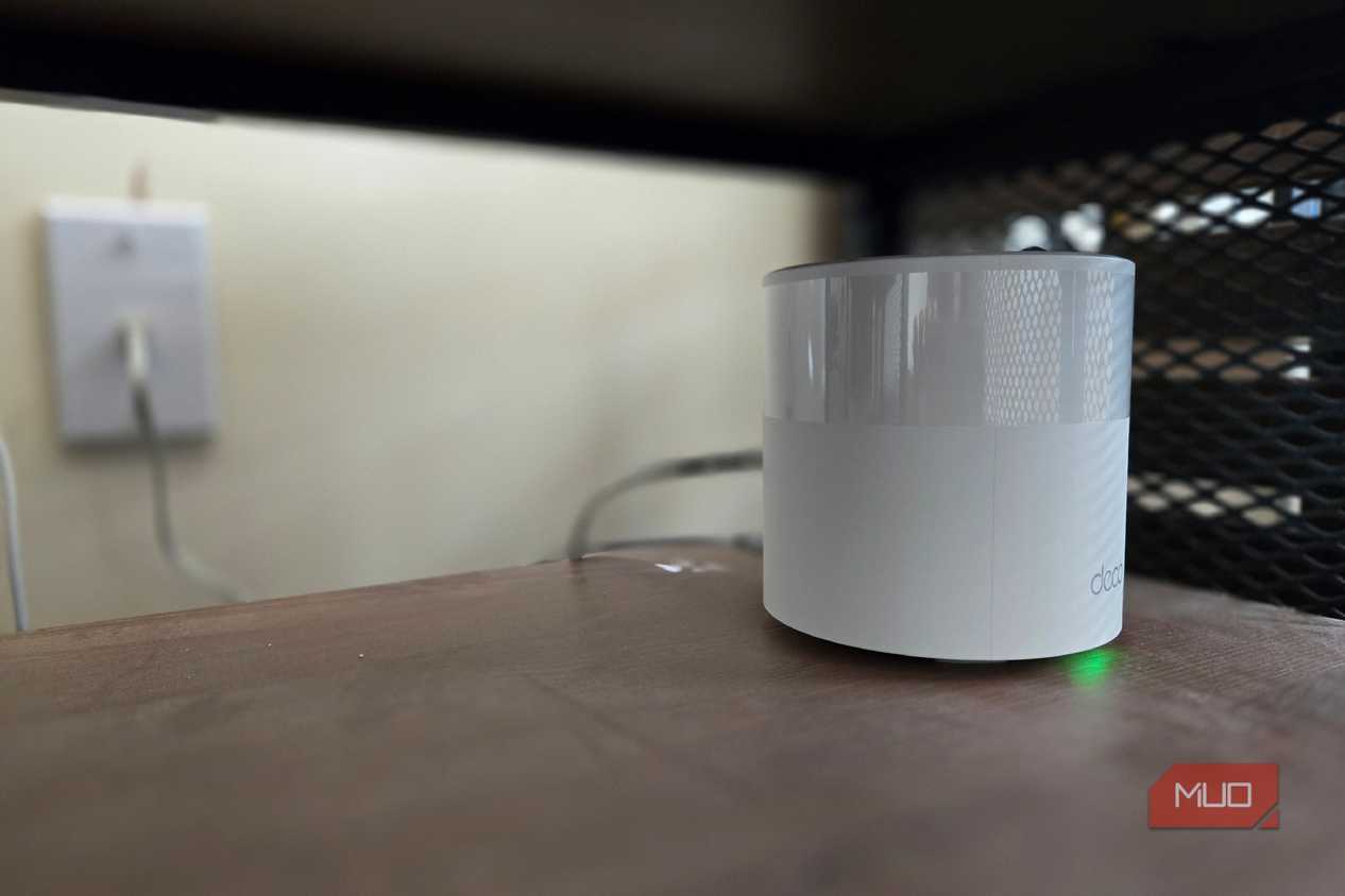 TP-Link Deco mesh Wi-Fi node on a shelf.