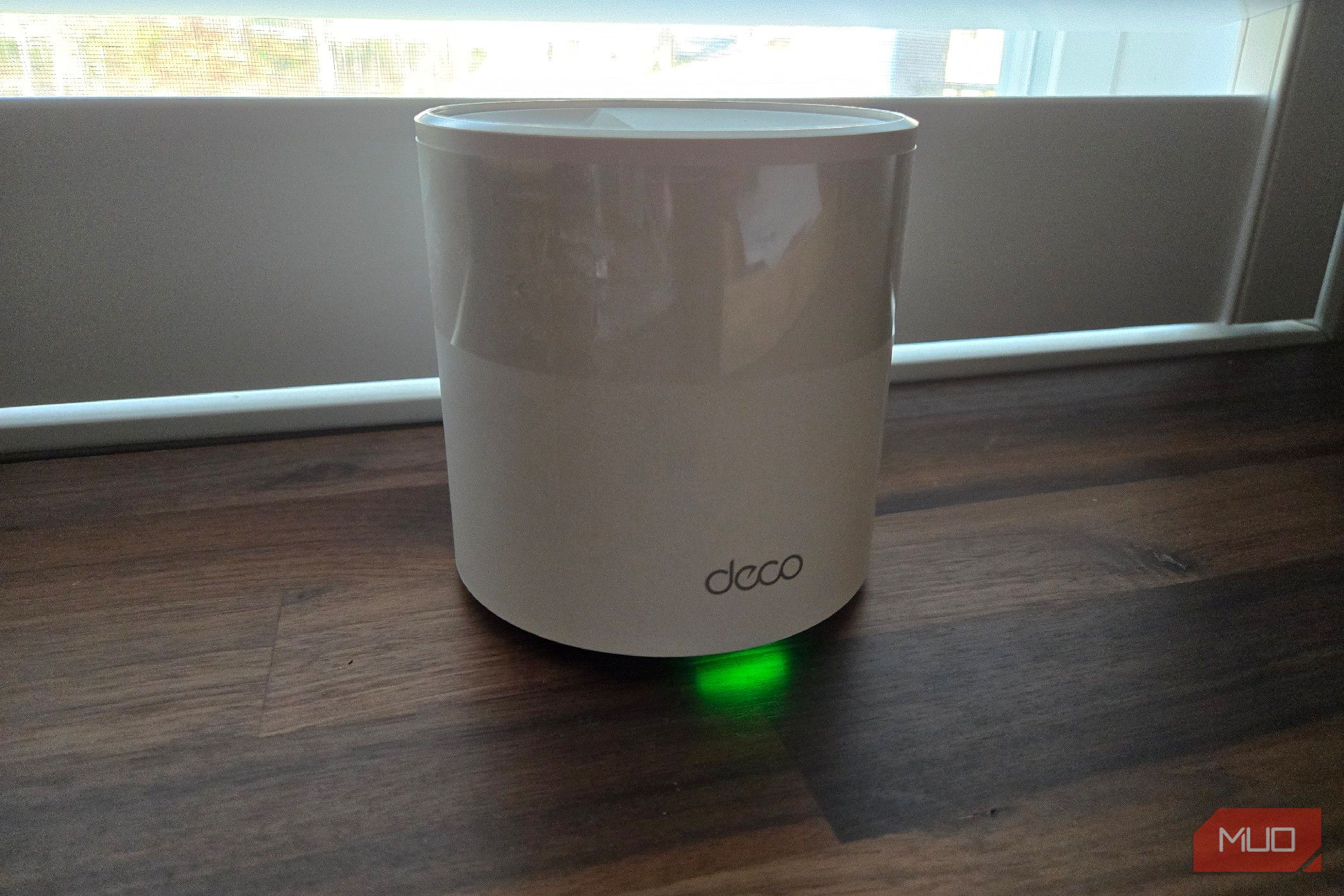 TP-Link Deco mesh Wi-Fi node on a desk. 