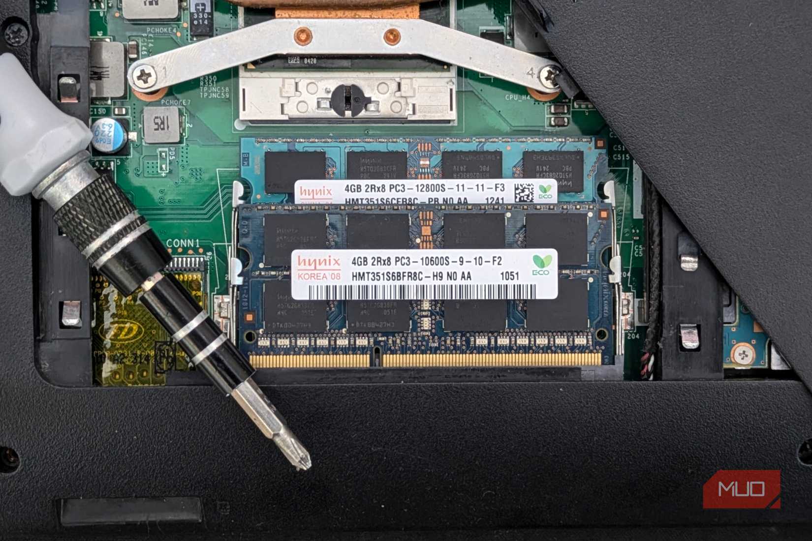 Laptop RAM in open laptop with a screwdriver.