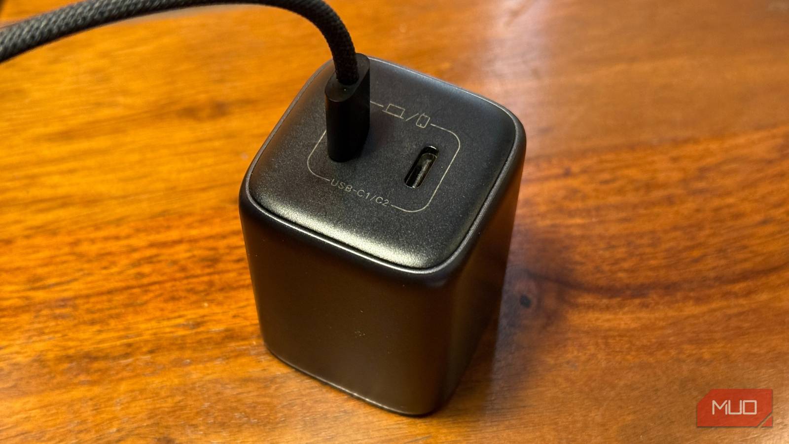 charger kept on a table with a cable plugged in