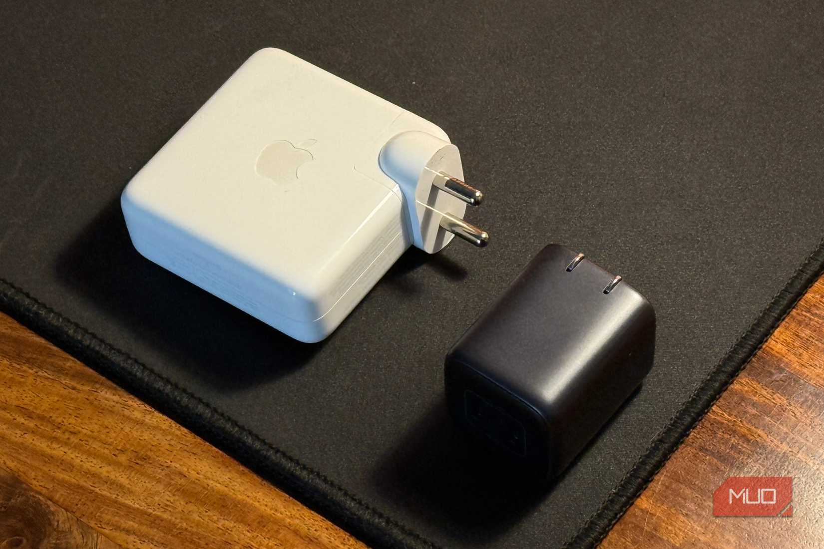 compact charger kept next to a larger macbook adapter