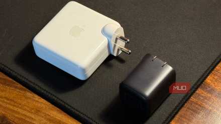 compact charger kept next to a larger macbook adapter