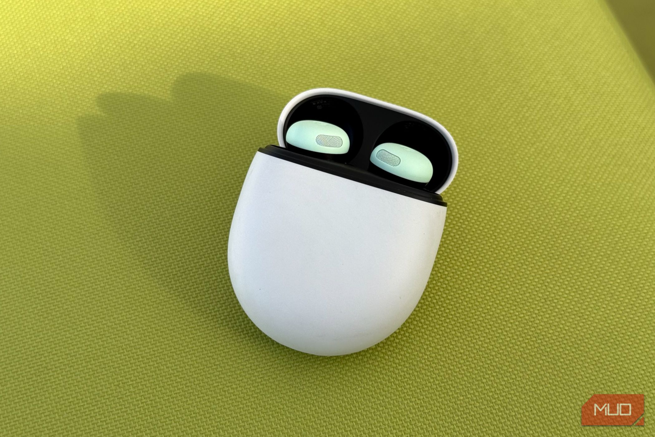 mint Pixel Buds Pro 2 on a green surface