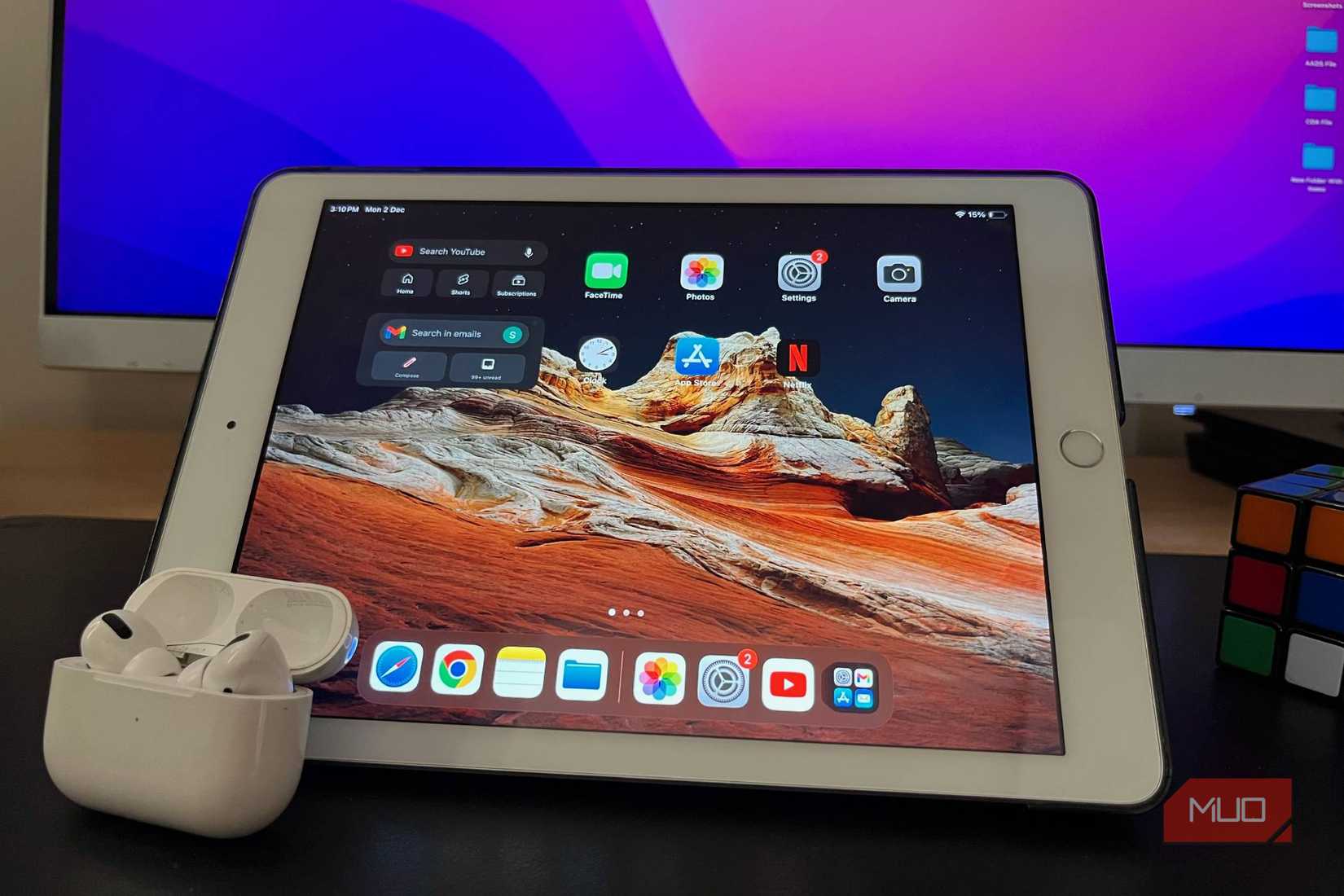 A 6th-generation iPad on a table with a pair of AirPods Pro placed on its screen.