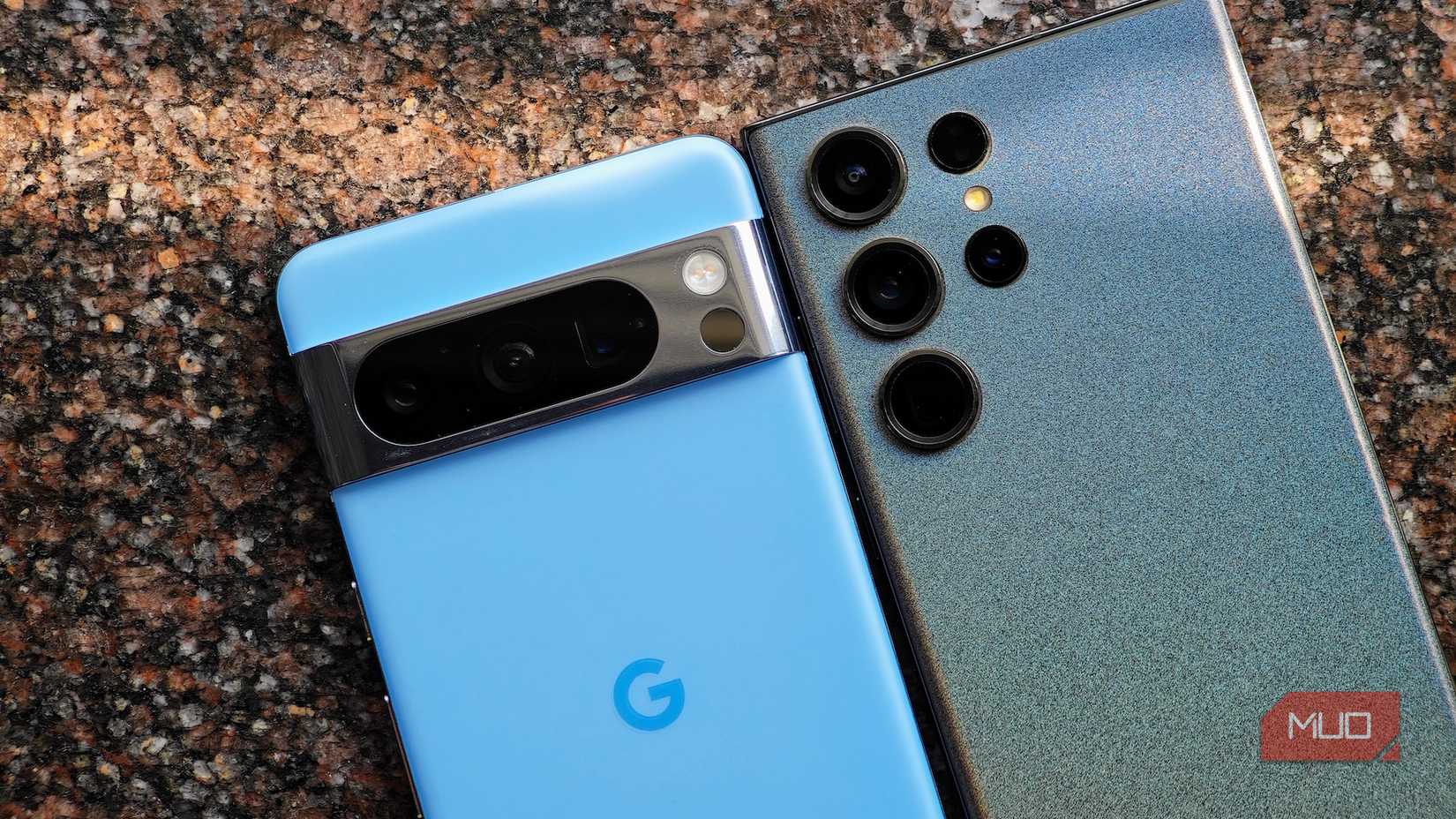 Google Pixel 8 Pro and Samsung Galaxy S23 Ultra lying face down next to each other