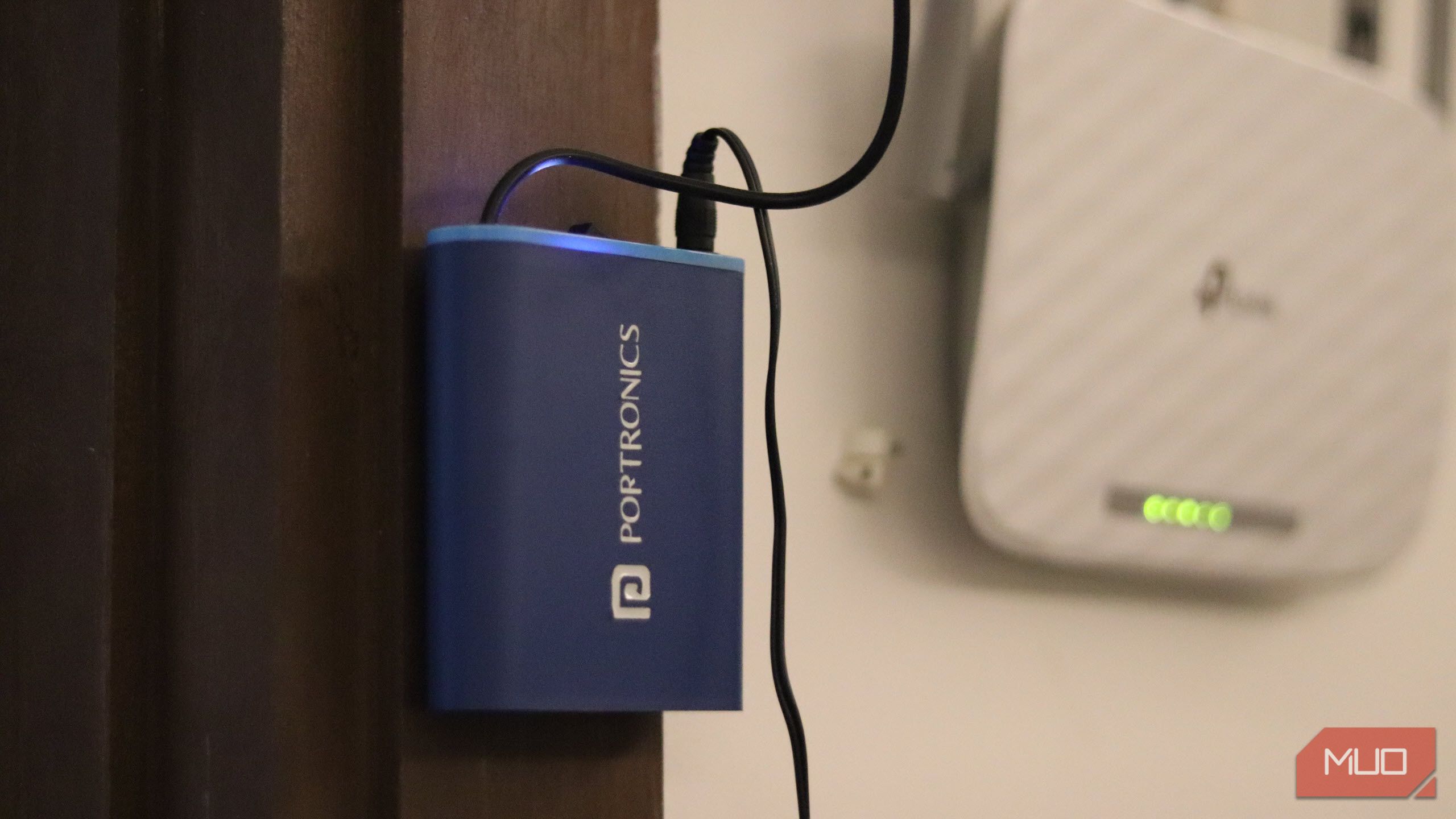 A router UPS mounted next to a Wi-Fi router