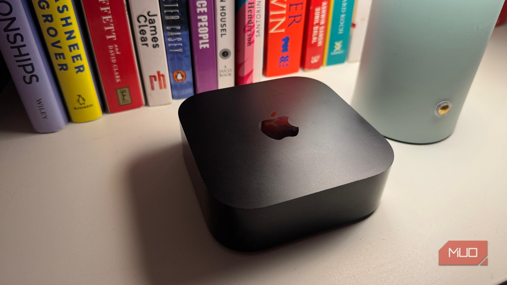 Apple TV with some books in the background